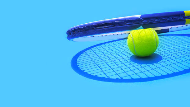 summer sport concept with tennis ball and racket on blue hard tennis court. - tennis court tennis ball racket imagens e fotografias de stock