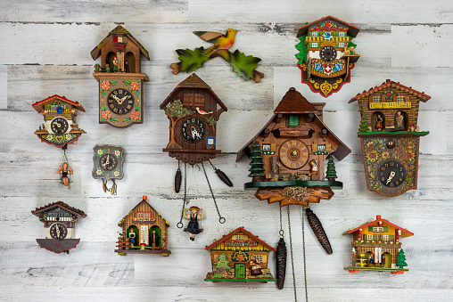 Collection of vintage cuckoo clocks and chalet banks