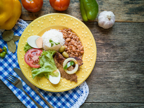 Traditional Brazilian food dish. Beans, rice, meat and salad.