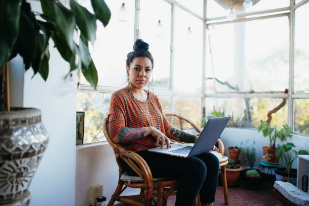 istock Latin entrepreneur working from home and looking to laptop 1217046681