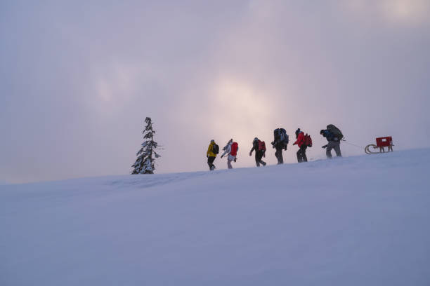 istock Friends hike through snow at dusk 1217048433