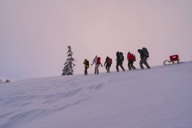 istock Friends hike through snow at dusk 1217048590