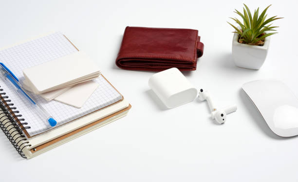 istock open paper notebooks and pen, computer mouse and green plants in a flowerpot on a white table, freelancer workplace 1217048732