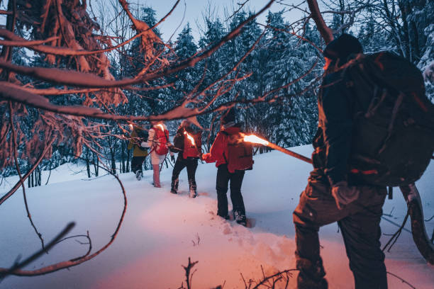 istock Friends hike through snow at dusk 1217049489