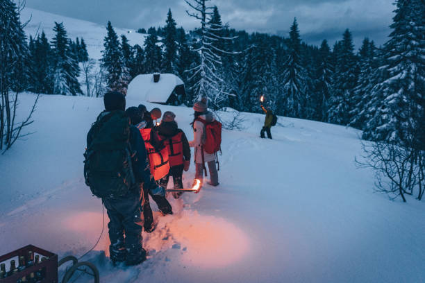 istock Friends hike through snow to log cabin 1217049512