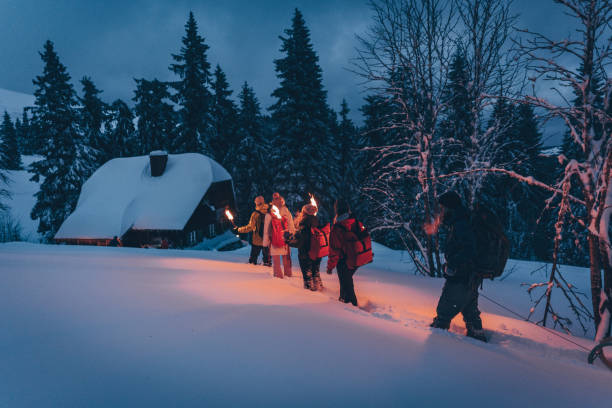 istock Friends hike through snow to log cabin 1217049531