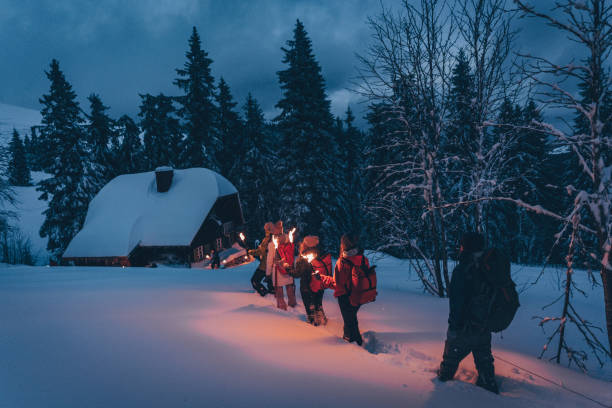 istock Friends hike through snow to log cabin 1217049660