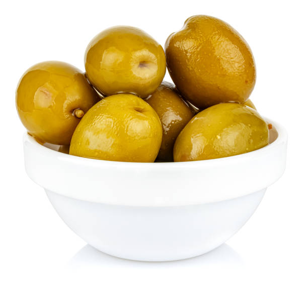 istock Whole green olives in a small white ceramic round bowl isolated on white background 1217050496