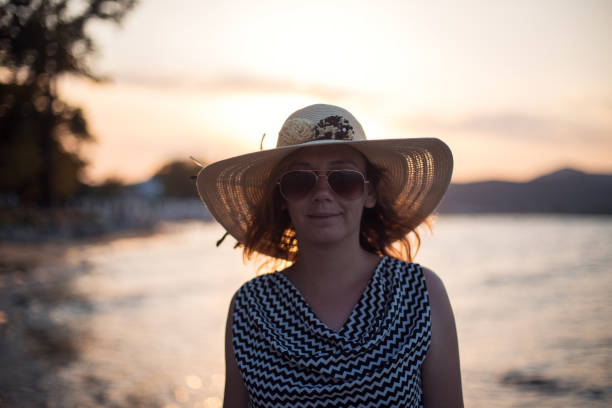 Young beautiful woman walking in sunset  on a beach