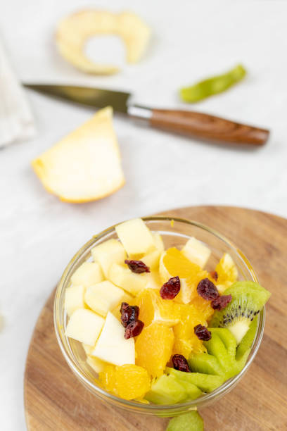 istock Fruit salad flat lay kiwi orange apple top view grey marble table 1217051746