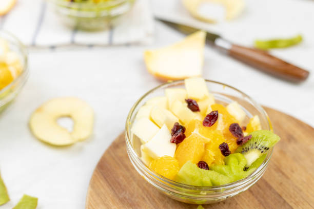 istock Fruit salad flat lay kiwi orange apple top view grey marble table 1217051748