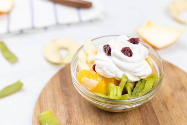 istock Fruit salad whipped cream flat lay white marble table 1217051887