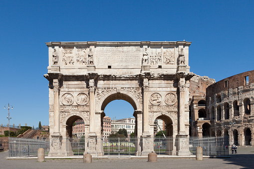 The Arch of Constantine (Arco di Costantino). \nTriumphal arch and Colosseum on background. Rome, Italy