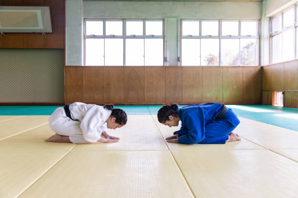 Female Judo athletes bowing before the match