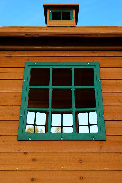 istock Wooden House with Green Plastic Windows and Blue Sky 121705456