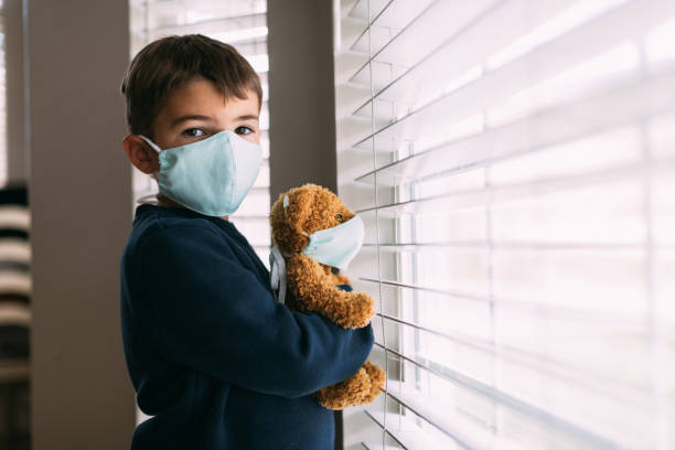Young Boy and his Teddy Wearing Face Masks
