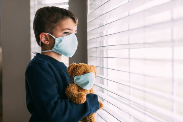 istock Young Boy and his Teddy Wearing Face Masks 1217055734