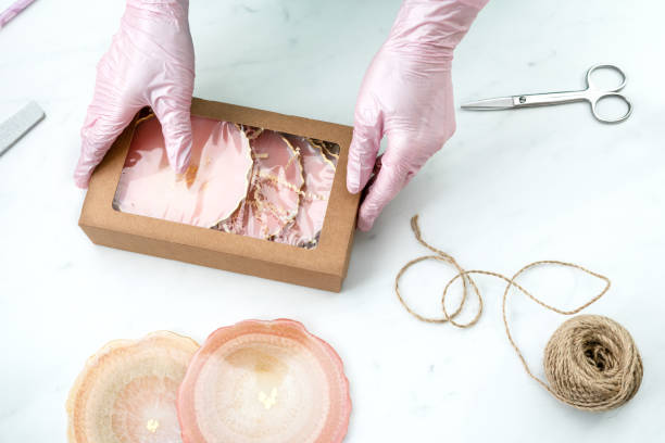 istock Creativity and craft. Resin coasters and packaging for them. Gift wrapping. Decorative packaging. Idea for business. Remote work, work at home. Art coasters. 1217056314