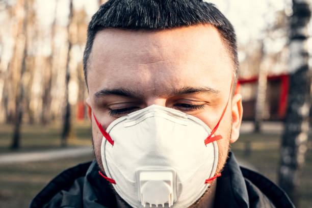 istock A man in a protective mask in an empty park. Face close up. Quarantine and self-isolation. Coronavirus pandemic. 1217056993