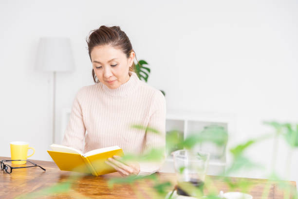 Asian senior age woman who reads a book