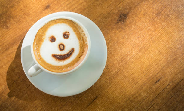 istock Cup of hot cappuccino coffee on wooden table. 1217058996