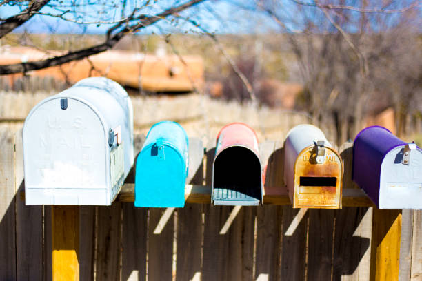 istock Line of Colorful Classic Rural US Mailboxes 1217063545