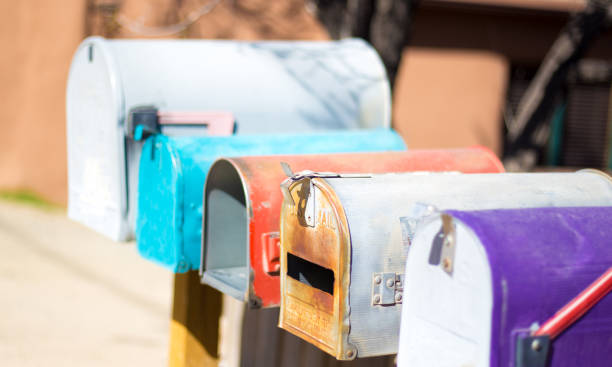 istock Line of Colorful Classic Rural US Mailboxes 1217064239
