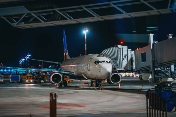 istock Airplane before flight in airport at night, sky transportation 1217067045