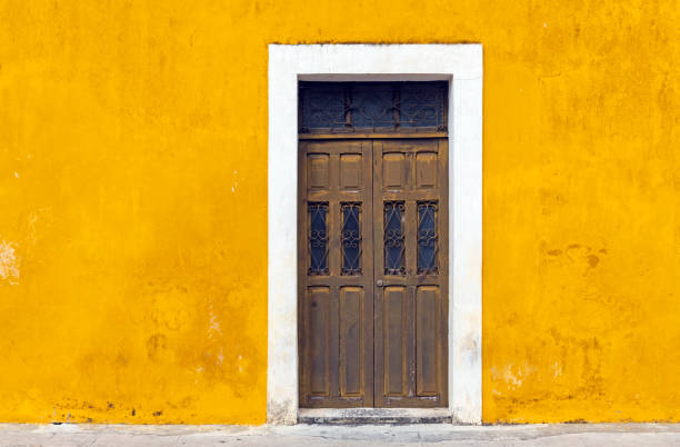Izamal Yellow Facade, Mexico Yellow wall facade and door in the city center of Izamal, Yucatan Peninsula, Mexico. valladolid mexico photos stock pictures, royalty-free photos & images