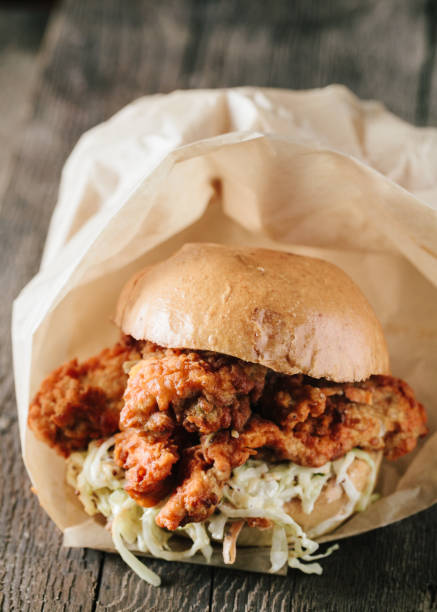istock Juicy fried chichen sandwich on a wooden surface 1217069663