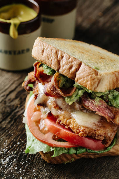 istock Overstuffed bacon lettuce and tomato sandwich on a wooden surface 1217069691