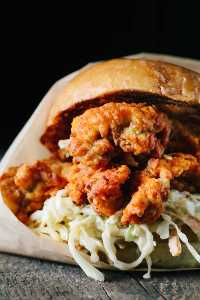istock Juicy fried chichen sandwich on a wooden surface 1217069717