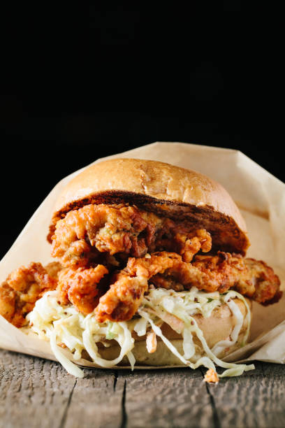 istock Juicy fried chichen sandwich on a wooden surface 1217069745