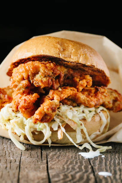 istock Juicy fried chichen sandwich on a wooden surface 1217069781