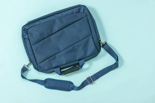 istock Blue laptop bag with belt on a blue background. 1217071859