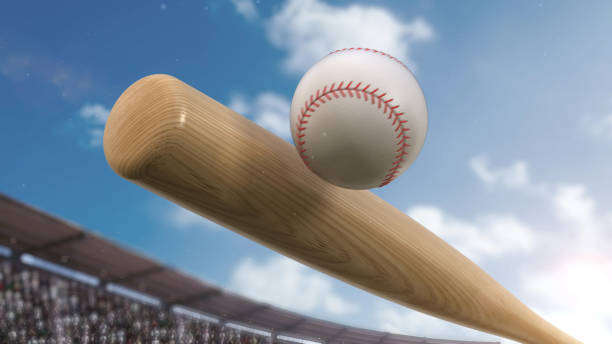 istock Baseball player hitting ball with bat in close up under stadium spotlights 1217072706