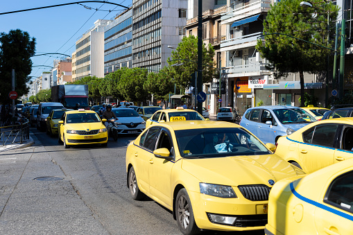 Athens, Greece - September 25, 2019: Group of taxis on the streets of Athens at rush hour in the morning