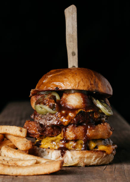 istock Gigantic Burger on a Wooden Surface 1217073980