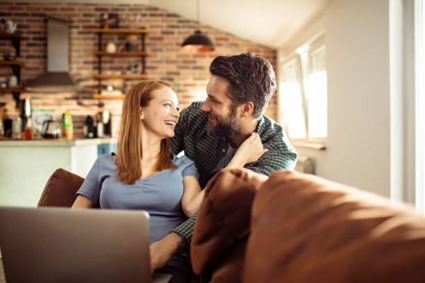 istock Young Couple using a Laptop at home 1217074800