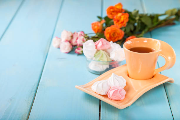 istock Romantic breakfast - zephyr, tea and roses on a table. Selective focus. Copy space. 1217075051