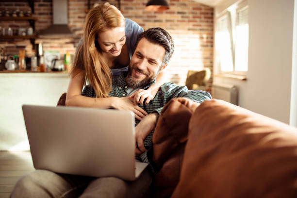 istock Young Couple using a Laptop at home 1217075097