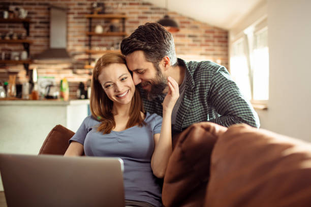 istock Young Couple using a Laptop at home 1217076781