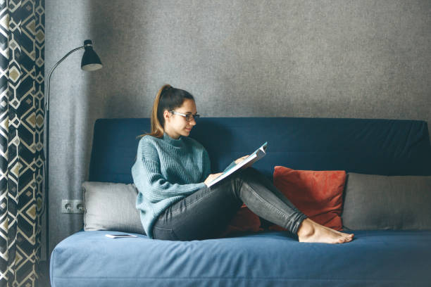 istock Girl reading a magazine 1217076902