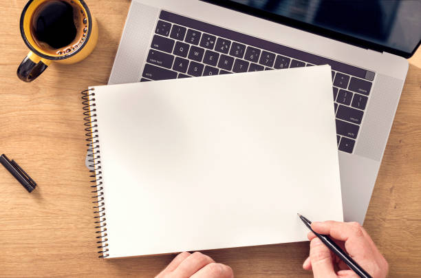 istock Male hand writes in notebook Online work or education concept 1217077949
