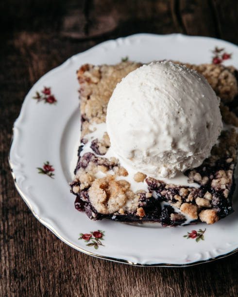 istock Homemade fresh blueberry pie with ice-cream on rustic background 1217078666