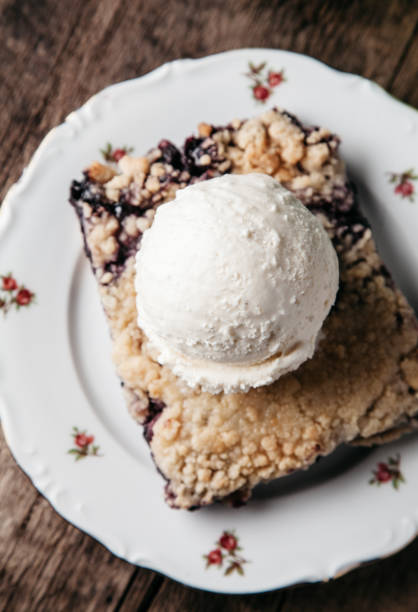 istock Homemade fresh blueberry pie with ice-cream on rustic background 1217079451