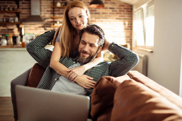 istock Young Couple using a Laptop at home 1217079458