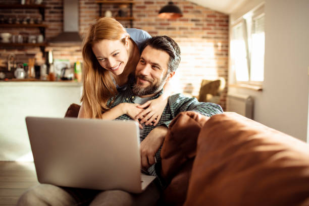 istock Young Couple using a Laptop at home 1217079525