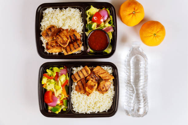 ready meal to eat on food container with drink and orange. - salad food and drink food lettuce imagens e fotografias de stock