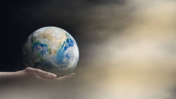 istock Hand holding blue planet earth in dark light. 1217083994